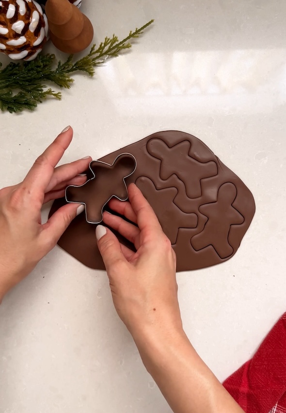 Cutting out Gingerbread men in oven bake clay
