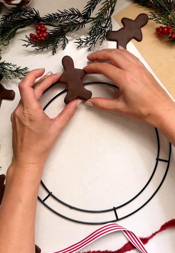 Glue and place gingerbread men on rail of wreath frame
