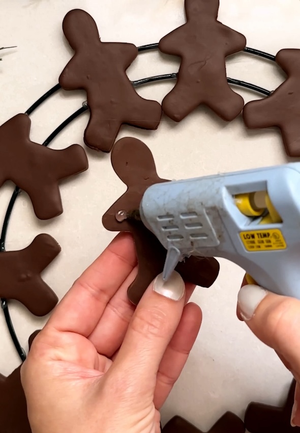 Add dollop of glue on hands and feet for gingerbread men on second row
