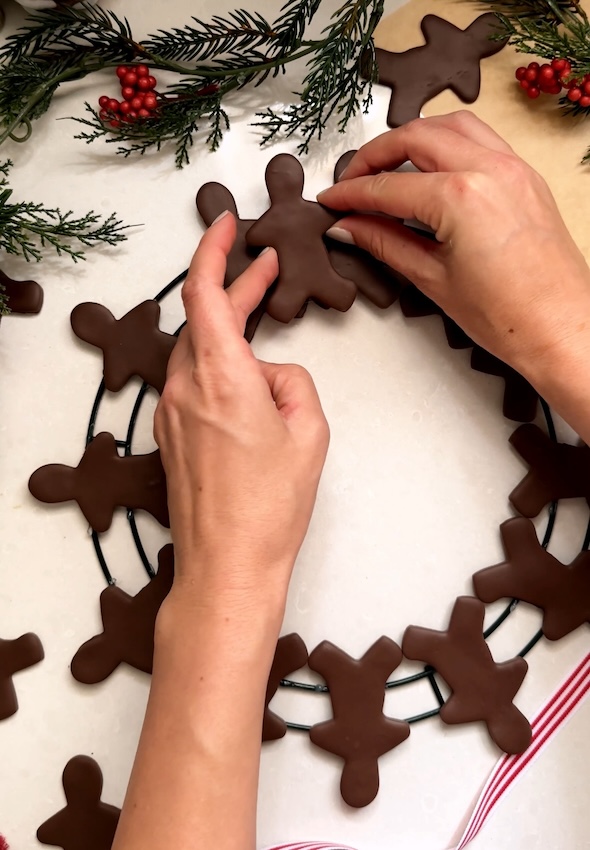 Place on top and in between two of first layer of gingerbread men
